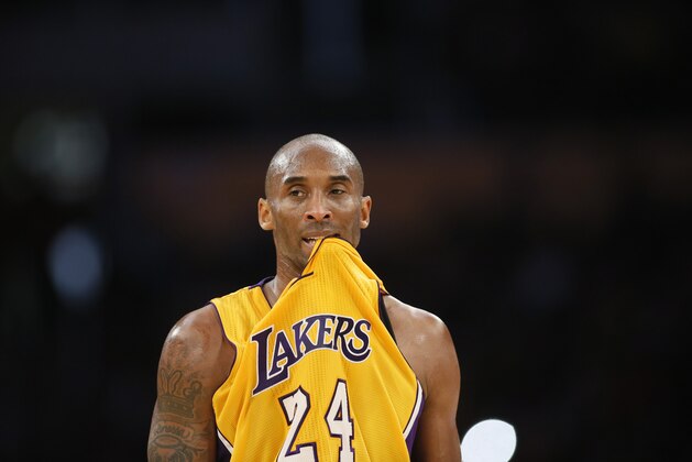 Los Angeles Lakers' Kobe Bryant bites his jersey in his mouth while he prepares to take free throws after being fouled while attempting a three-pointer against the Milwaukee Bucks during the second half of an NBA basketball game, Tuesday, Dec. 15, 2015, in Los Angeles. The Lakers won 113-95. (AP Photo/Danny Moloshok)
