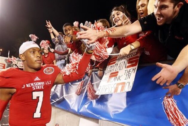 Jacksonville State quarterback Eli Jenkins (7) celebrates with fans after his team defeated Charleston Southern 58-38 in an NCAA college football game, Friday, Dec. 11, 2015, in Jacksonville, Ala. (AP Photo/ Butch Dill)