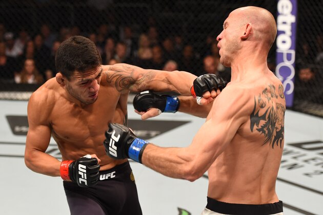 ORLANDO, FL - DECEMBER 19:   (L-R) Rafael dos Anjos punches Donald Cerrone in their UFC lightweight title bout during the UFC Fight Night event at the Amway Center on December 19, 2015 in Orlando, Florida. (Photo by Josh Hedges/Zuffa LLC/Zuffa LLC via Getty Images)