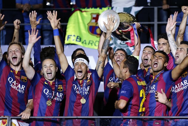 FILE - In this Saturday June 6, 2015 file photo, Barcelona players celebrate with the trophy after winning the Champions League final soccer match against Juventus Turin at the Olympic stadium in Berlin. Barcelona won the match 3-1. (AP Photo/Luca Bruno, File)