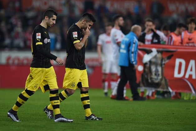 Dortmund's Armenian midfielder Henrikh Mkhitaryan and Dortmund's midfielder Ilkay Guendogan react after the German first division Bundesliga football match 1 FC Cologne vs Borussia Dortmund in Cologne, western Germany, on December 19, 2015. 

 / AFP / PATRIK STOLLARZ / RESTRICTIONS: DURING MATCH TIME: DFL RULES TO LIMIT THE ONLINE USAGE TO 15 PICTURES PER MATCH AND FORBID IMAGE SEQUENCES TO SIMULATE VIDEO. == RESTRICTED TO EDITORIAL USE == FOR FURTHER QUERIES PLEASE CONTACT DFL DIRECTLY AT + 49 69 650050
        (Photo credit should read PATRIK STOLLARZ/AFP/Getty Images)