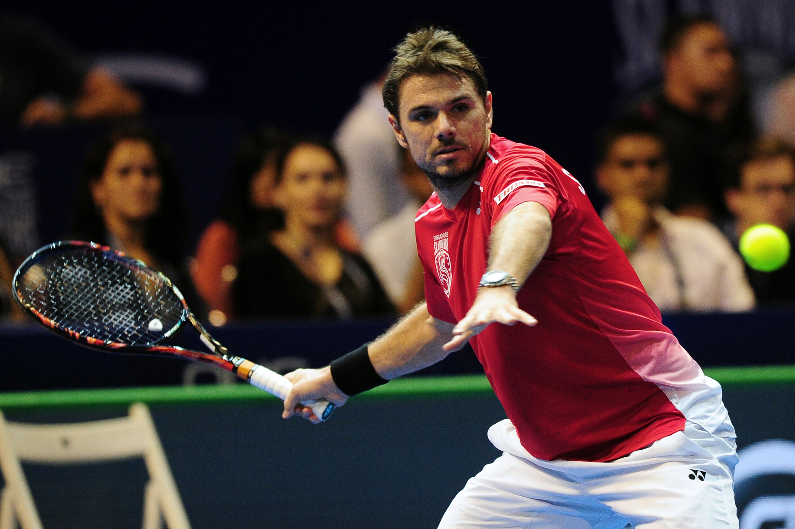 Switzerland's Stan Wawrinka of Singapore Slammers hits a return against Australia's Bernard Tomic of Indian Aces during their men's singles tennis match at the International Premier Tennis League (IPTL) tournament in Singapore on December 19, 2015. AFP PHOTO /MOHD FYROL / AFP / MOHD FYROL        (Photo credit should read MOHD FYROL/AFP/Getty Images)