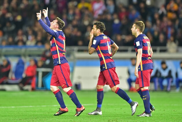 Barcelona forward Lionel Messi (L) celebrates his goal against River Plate during the Club World Cup football final in Yokohama on December 20, 2015.  AFP PHOTO / YOSHIKAZU TSUNO / AFP / YOSHIKAZU TSUNO        (Photo credit should read YOSHIKAZU TSUNO/AFP/Getty Images)