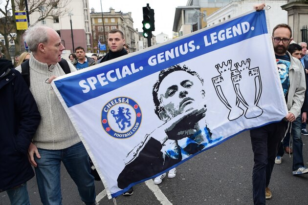 Supporters carry a flag in support of Chelsea's former Portuguese manager Jose Mourinho before the English Premier League football match between Chelsea and Sunderland at Stamford Bridge in London on December 19, 2015. Jose Mourinho attended the Championship match between Brighton and Hove Albion and Middlesbrough today in his first public appearance since being sacked as Chelsea manager on Thursday.
AFP PHOTO / LEON NEAL / AFP / LEON NEAL        (Photo credit should read LEON NEAL/AFP/Getty Images)