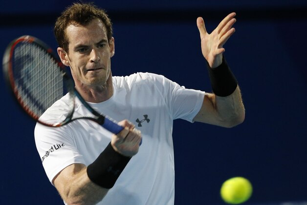 Britain's Andy Murray of OUE Singapore Slammers hits a return to Australia's Bernard Tomic of Micromax Indian Aces during their tennis match in the men's singles of the International Premier Tennis League (IPTL) on December 16, 2015 in the United Emirate of Dubai. AFP PHOTO / KARIM SAHIB / AFP / KARIM SAHIB        (Photo credit should read KARIM SAHIB/AFP/Getty Images)