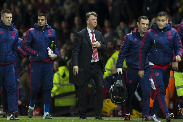 Manchester United's manager Louis van Gaal, centre, makes his way from the pitch after his team's 2-1 loss to Norwich City in the English Premier League soccer match between Manchester United and Norwich City at Old Trafford Stadium, Manchester, England, Saturday, Dec. 19, 2015. (AP Photo/Jon Super)