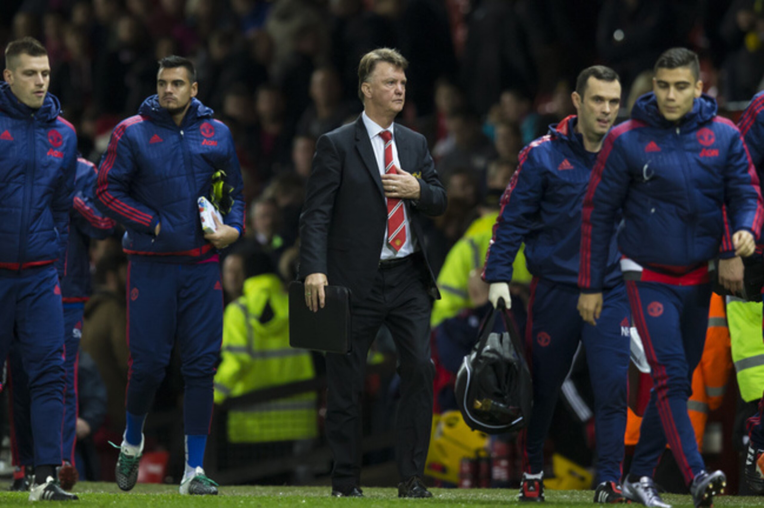 Manchester United's manager Louis van Gaal, centre, makes his way from the pitch after his team's 2-1 loss to Norwich City in the English Premier League soccer match between Manchester United and Norwich City at Old Trafford Stadium, Manchester, England, Saturday, Dec. 19, 2015. (AP Photo/Jon Super)