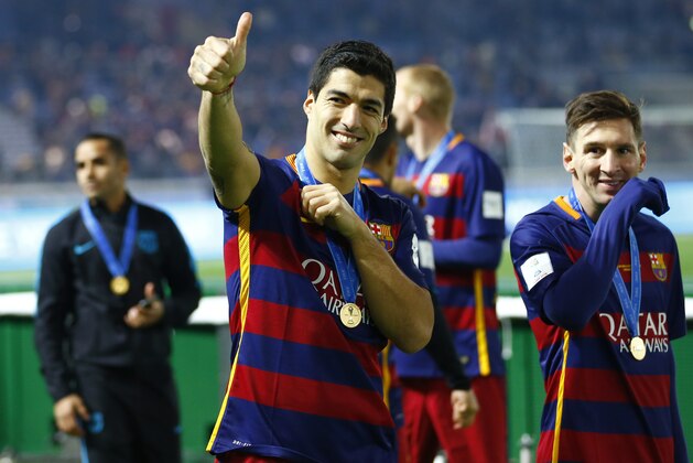 FC Barcelona’s Luis Suarez shows a thumbs-up next to teammate Lionel Messi, right, as he celebrates after beating River Plate 3-0 in heir final match at the FIFA Club World Cup soccer tournament in Yokohama, near Tokyo, Sunday, Dec. 20, 2015. (AP Photo/Shizuo Kambayashi)