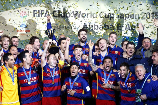 FC Barcelona’s Andres Iniesta holds up the trophy as he celebrates with teammates during an award ceremony after defeating River Plate 3-0 in their final match at the FIFA Club World Cup soccer tournament in Yokohama, near Tokyo, Sunday, Dec. 20, 2015. (AP Photo/Shizuo Kambayashi)