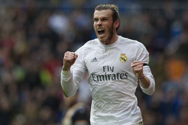 Real Madrid's Welsh forward Gareth Bale celebrates after scoring during the Spanish league football match Real Madrid CF vs Rayo Vallecano de Madrid at the Santiago Bernabeu stadium in Madrid on December 20, 2015.   AFP PHOTO/ CURTO DE LA TORRE / AFP / CURTO DE LA TORRE        (Photo credit should read CURTO DE LA TORRE/AFP/Getty Images)