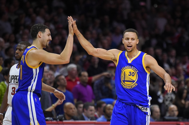 Golden State Warriors guard Stephen Curry, right, celebrates with guard Klay Thompson, center as Los Angeles Clippers guard Chris Paul walks by during the second half of an NBA basketball game, Thursday, Nov. 19, 2015, in Los Angeles.  The Warriors won 124-117. (AP Photo/Mark J. Terrill)