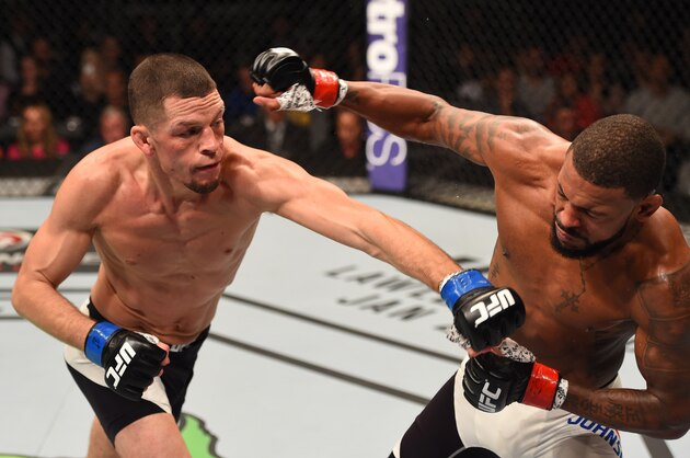 ORLANDO, FL - DECEMBER 19:   (L-R) Nate Diaz punches Michael Johnson in their lightweight bout during the UFC Fight Night event at the Amway Center on December 19, 2015 in Orlando, Florida. (Photo by Josh Hedges/Zuffa LLC/Zuffa LLC via Getty Images)