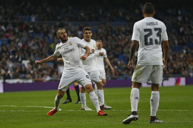 Real Madrid's Karim Benzema, left, celebrates after scoring a goal against Rayo Vallecano during the Spanish La Liga soccer match between Real Madrid and Rayo Vallecano at the Santiago Bernabeu stadium in Madrid, Sunday, Dec. 20, 2015. Benzema scored three times in Real Madrid's 10-2 victory. (AP Photo/Francisco Seco)
