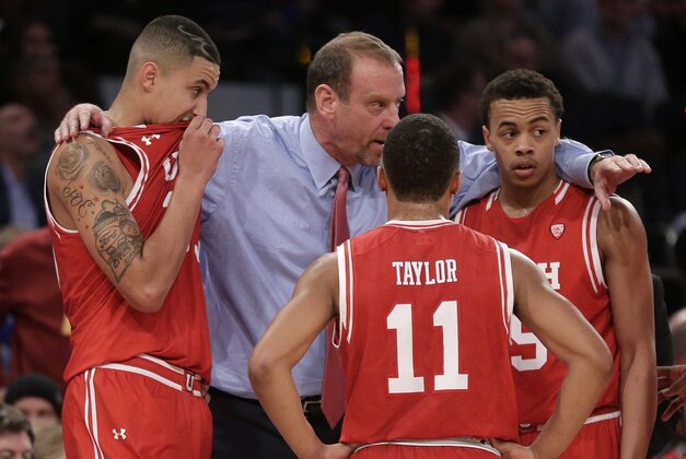 Utah head coach Larry Krystkowiak gathers his players during a timeout in overtime of an NCAA college basketball game against Duke, Saturday, Dec. 19, 2015, in New York. Utah won 77-75. (AP Photo/Julie Jacobson)