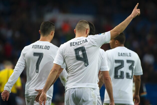 Real Madrid's French forward Karim Benzema (C) celebrates after scoring during the Spanish league football match Real Madrid CF vs Rayo Vallecano de Madrid at the Santiago Bernabeu stadium in Madrid on December 20, 2015. Real Madrid won 10-2.   AFP PHOTO/ CURTO DE LA TORRE / AFP / CURTO DE LA TORRE        (Photo credit should read CURTO DE LA TORRE/AFP/Getty Images)