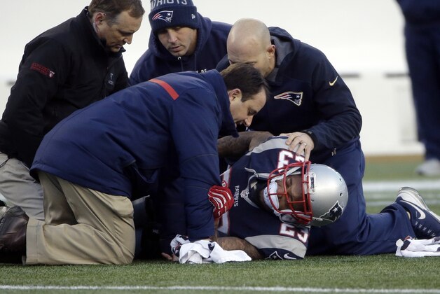 New England Patriots safety Patrick Chung (23) receives attention after an injury in the second half of an NFL football game against the Tennessee Titans, Sunday, Dec. 20, 2015, in Foxborough, Mass. (AP Photo/Steven Senne)
