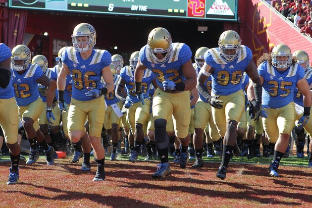 LOS ANGELES, CA - NOVEMBER 28:  The UCLA Bruins take to the field against the USC Trojans in a NCAA PAC12 college football game at Los Angeles Memorial Coliseum on November 28, 2015 in Los Angeles, California.  (Photo by Leon Bennett/Getty Images)