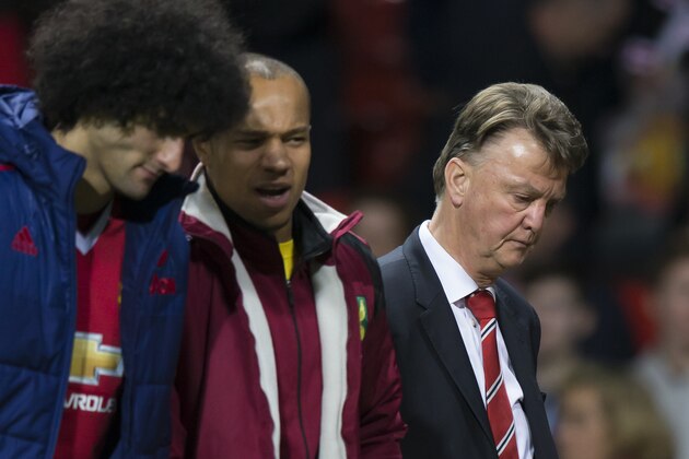 Manchester United's manager Louis van Gaal, right, makes his way from the pitch after his team's 2-1 loss to Norwich City in the English Premier League soccer match between Manchester United and Norwich City at Old Trafford Stadium, Manchester, England, Saturday, Dec. 19, 2015. (AP Photo/Jon Super)