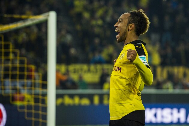 Dortmund's Gabonese midfielder Pierre-Emerick Aubameyang celebrates scoring his side's 5th goal to complete his hat-trick during the German first division football Bundesliga match between Borussia Dortmund and FC Augsburg on October 25, 2015 in Dortmund, western Germany. Dortmund won the match 5-1. AFP PHOTO / ODD ANDERSEN
RESTRICTIONS: DURING MATCH TIME: DFL RULES TO LIMIT THE ONLINE USAGE TO 15 PICTURES PER MATCH AND FORBID IMAGE SEQUENCES TO SIMULATE VIDEO. 
==RESTRICTED TO EDITORIAL USE ==
FOR FURTHER QUERIES PLEASE CONTACT THE DFL DIRECTLY AT + 49 69 650050.        (Photo credit should read ODD ANDERSEN/AFP/Getty Images)