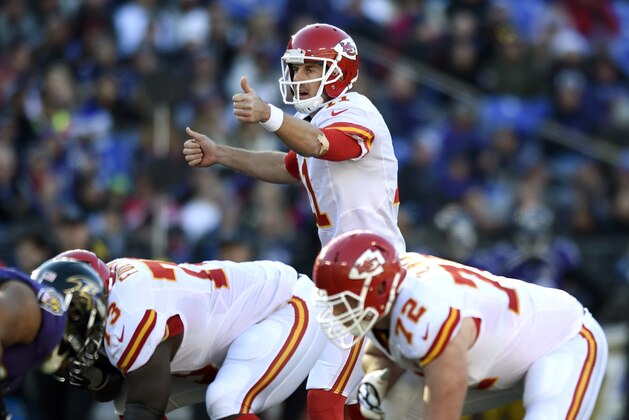 Kansas City Chiefs quarterback Alex Smith, center, prepares to run a play in the first half of an NFL football game against the Baltimore Ravens, Sunday, Dec. 20, 2015, in Baltimore. (AP Photo/Gail Burton)