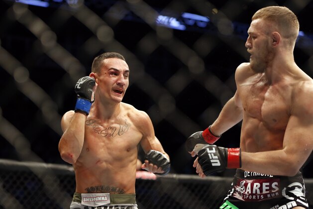 Conor McGregor, right, in action against Max Holloway in their UFC on Fox Sports 1 mixed martial arts bout in Boston, Saturday, August 17,2013. McGregor won via unanimous decision. (AP Photo/Gregory Payan)