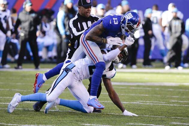 A referee separates New York Giants wide receiver Odell Beckham (13) and Carolina Panthers' Josh Norman (24)  during the first half of an NFL football game Sunday, Dec. 20, 2015, in East Rutherford, N.J. (AP Photo/Julie Jacobson)