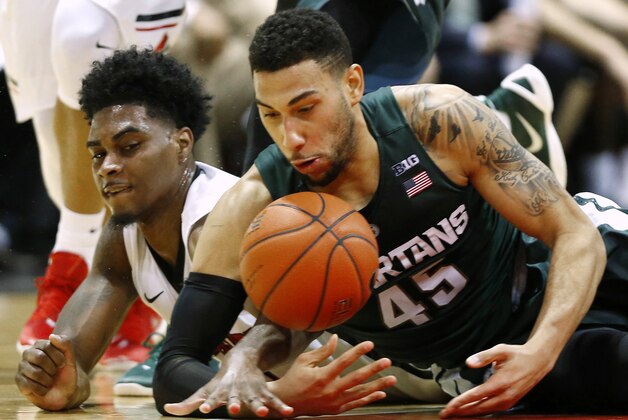 Michigan State's Denzel Valentine (45) battles for a loose ball against Northeastern's Quincy Ford during the first quarter of an NCAA college basketball game in Boston Saturday, Dec. 19, 2015. (AP Photo/Winslow Townson)