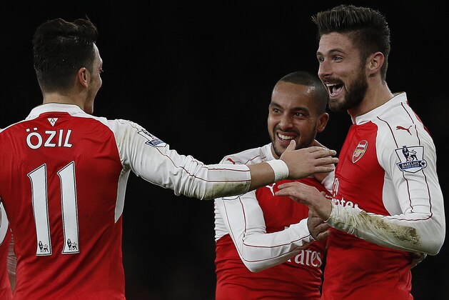 Arsenal's French striker Olivier Giroud (R) celebrates scoring his team's second goal with Arsenal's English midfielder Theo Walcott (R) and Arsenal's German midfielder Mesut Ozil during the English Premier League football match between Arsenal and Manchester City at the Emirates Stadium in London on December 21, 2015. AFP PHOTO / ADRIAN DENNIS

RESTRICTED TO EDITORIAL USE. No use with unauthorized audio, video, data, fixture lists, club/league logos or 'live' services. Online in-match use limited to 75 images, no video emulation. No use in betting, games or single club/league/player publications. / AFP / ADRIAN DENNIS        (Photo credit should read ADRIAN DENNIS/AFP/Getty Images)