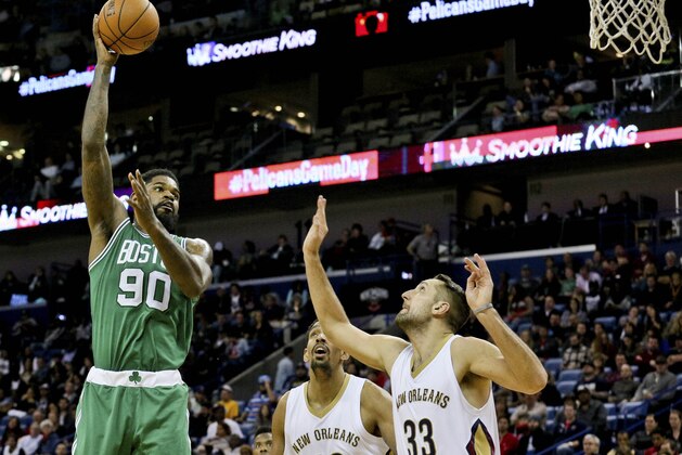 Dec 7, 2015; New Orleans, LA, USA; Boston Celtics forward Amir Johnson (90) shoots over New Orleans Pelicans forward Ryan Anderson (33) and center Alexis Ajinca (42) during the second half of a game at the Smoothie King Center. The Celtics defeated the Pelicans 111-93. Mandatory Credit: Derick E. Hingle-USA TODAY Sports