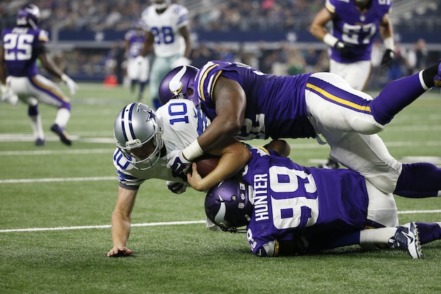 Dallas Cowboys' Dustin Vaughan (10) is sacked by Minnesota Vikings' Danielle Hunter (99) with help from Chad Greenway (52) during the second half of a preseason NFL football game Saturday, Aug. 29, 2015, in Arlington, Texas. (AP Photo/Tony Gutierrez)