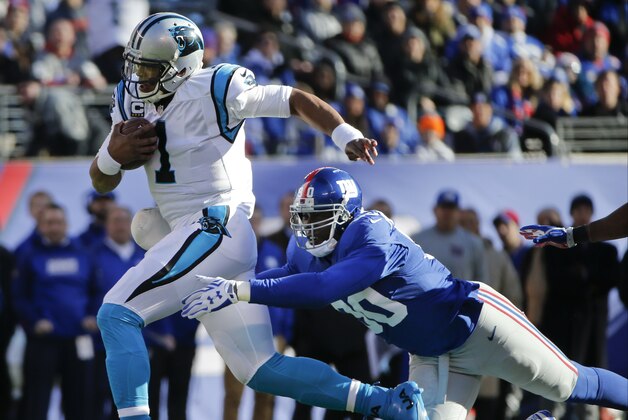 Carolina Panthers quarterback Cam Newton (1) breaks a tackle by New York Giants' Jason Pierre-Paul (90) during the first half of an NFL football game Sunday, Dec. 20, 2015, in East Rutherford, N.J. (AP Photo/Kathy Willens)