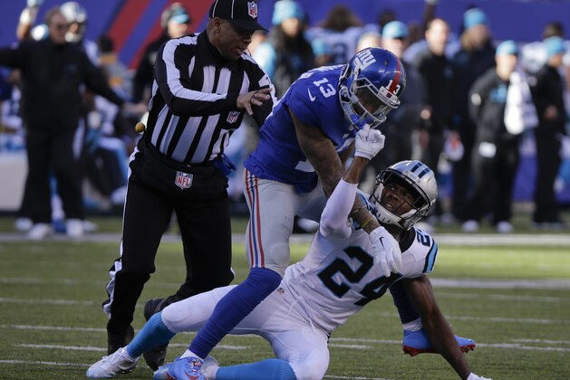A referee steps in to separate New York Giants wide receiver Odell Beckham (13) and Carolina Panthers' Josh Norman (24) as they scuffle during the first half of an NFL football game Sunday, Dec. 20, 2015, in East Rutherford, N.J. (AP Photo/Julie Jacobson)