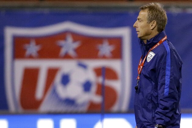 United States men's national soccer team coach Jurgen Klinsmann watches his team warm up during practice Thursday, Nov. 12, 2015, in St. Louis. The U.S. team is scheduled to play a World Cup qualifying match against St. Vincent and the Grenadines on Friday in St. Louis. (AP Photo/Jeff Roberson)
