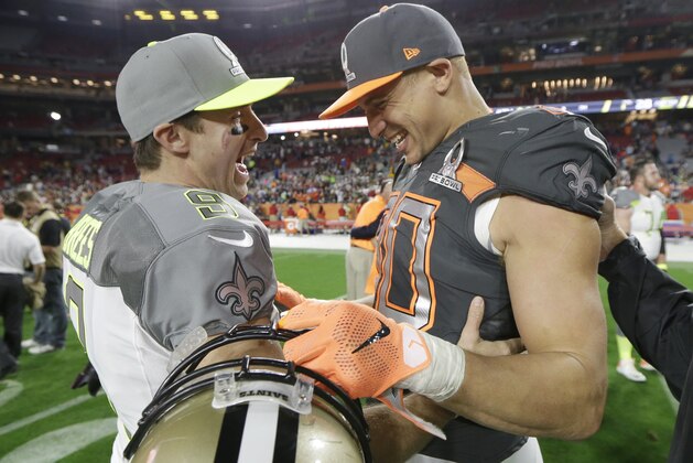 New Orleans Saints' Drew Brees chats with New Orleans Saints' Jimmy Graham after Team Irvin defeated Team Carter 32-28 in the NFL Football Pro Bowl Sunday, Jan. 25, 2015, in Glendale, Ariz. (AP Photo/Mark Humphrey)
