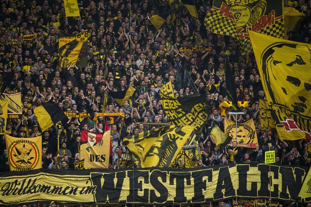 Dortmund's fans cheer during the German first division football Bundesliga match between Borussia Dortmund and FC Augsburg on October 25, 2015 in Dortmund, western Germany. Dortmund wom the match 5-1. AFP PHOTO / ODD ANDERSEN        (Photo credit should read ODD ANDERSEN/AFP/Getty Images)