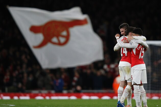 Arsenal's French striker Olivier Giroud (L), Arsenal's Spanish defender Hector Bellerin (C) and Arsenal's English midfielder Alex Oxlade-Chamberlain celebrate following the English Premier League football match between Arsenal and Manchester City at the Emirates Stadium in London on December 21, 2015. Arsenal won the match 2-1.   AFP PHOTO / ADRIAN DENNIS

RESTRICTED TO EDITORIAL USE. No use with unauthorized audio, video, data, fixture lists, club/league logos or 'live' services. Online in-match use limited to 75 images, no video emulation. No use in betting, games or single club/league/player publications. / AFP / ADRIAN DENNIS        (Photo credit should read ADRIAN DENNIS/AFP/Getty Images)