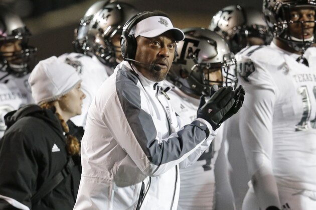 Texas A&M head coach Kevin Sumlin, center, watches a replay on the scoreboard in the first half of an NCAA college football game against Vanderbilt, Saturday, Nov. 21, 2015, in Nashville, Tenn. (AP Photo/Mark Humphrey)