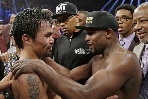 FILE - This May 2, 2015 file photo shows Manny Pacquiao, from the Philippines, left, and Floyd Mayweather Jr., embrace in the ring at the finish of their welterweight title fight in Las Vegas. Boxing fans across the country or at least their lawyers are calling the hyped-up fight between Pacquiao and Mayweather a fraud. Some 31 class action lawsuits had been filed through Friday alleging primarily the same thing: that Pacquiao's pre-existing shoulder injury should have been disclosed to fans ahead of time. (AP Photo/Isaac Brekken,File)