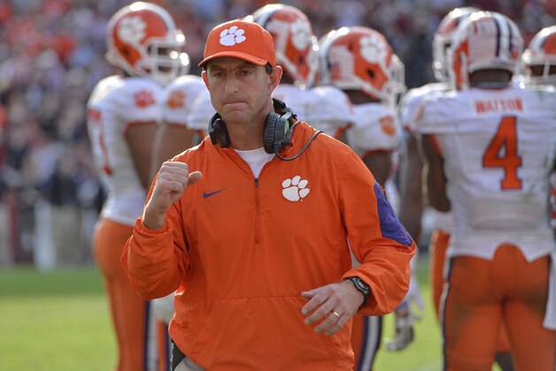 FILE - In this Nov. 28, 2015 file photo, Clemson head coach Dabo Swinney reacts in the closing minutes of an NCAA college football game against South Carolina in Columbia,  S.C.  Swinney is three victories away from winning a national championship. (AP Photo/Richard Shiro)