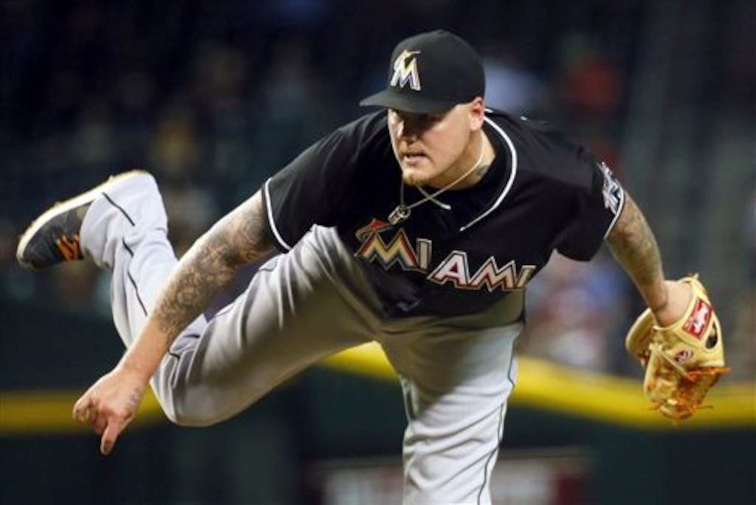 FILE - In this July 21, 2015, file photo, Miami Marlins starting pitcher Mat Latos throws during the seventh inning of a baseball game against the Arizona Diamondbacks in Phoenix. The first-place Los Angeles Dodgers have bolstered their pitching staff, acquiring from the Marlins and Alex Wood, Jim Johnson and Luis Avilan from the Atlanta Braves in a 13-player deal Thursday, July 30, 2015. (AP Photo/Matt York, File)
