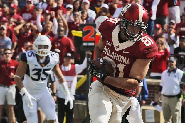 Oklahoma tight end Mark Andrews takes a Baker Mayfield pass in for a touchdown in the first quarter of an NCAA college football game against West Virginia in Norman, Okla., Saturday, Oct. 3, 2015. (AP Photo/Sue Ogrocki)