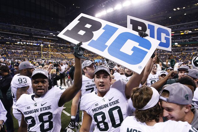 INDIANAPOLIS, IN - DECEMBER 5: Madre London #28 and Dylan Chmura #80 of the Michigan State Spartans celebrate after the Big Ten Championship against the Iowa Hawkeyes at Lucas Oil Stadium on December 5, 2015 in Indianapolis, Indiana. Michigan State defeated Iowa 16-13. (Photo by Joe Robbins/Getty Images)