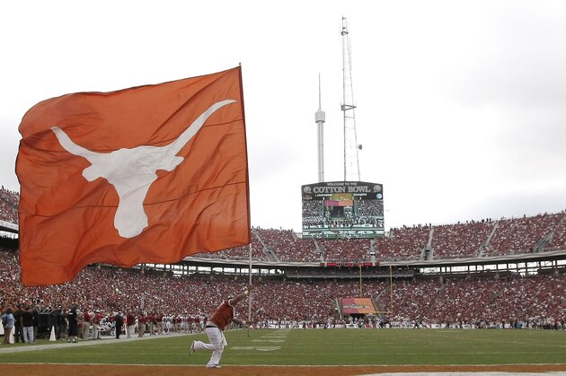 A Texas longhorn flag is carried across the field during the first half of an NCAA college football game against the Oklahoma at the Cotton Bowl  Saturday, Oct. 12, 2013, in Dallas. (AP Photo/Brandon Wade)
