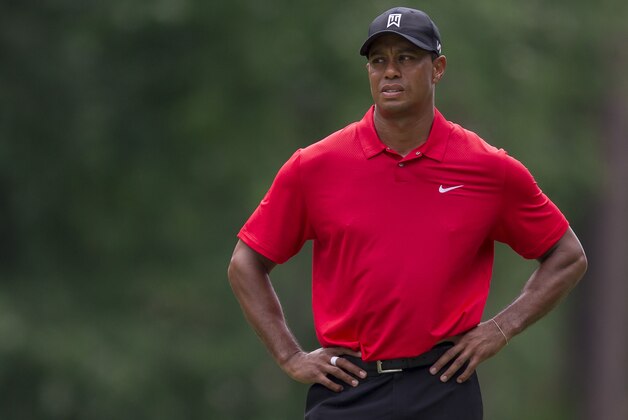 Tiger Woods pauses to consider his second shot on the fifth hole during the final round of the Wyndham Championship golf tournament at Sedgefield Country Club in Greensboro, N.C., Sunday, Aug. 23, 2015. (AP Photo/Rob Brown)