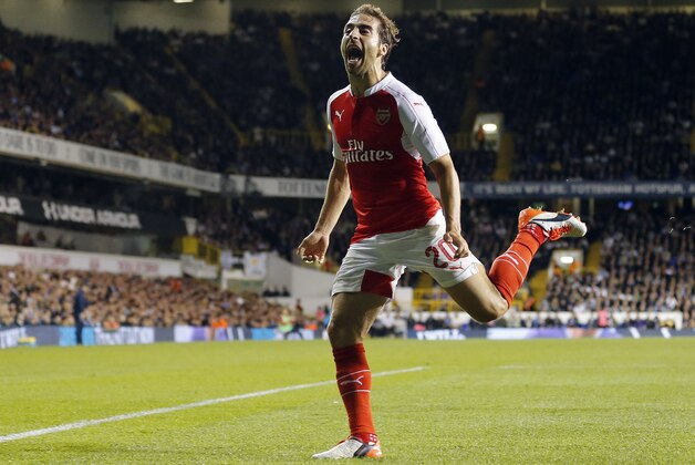 Arsenal's Mathieu Flamini  celebrates after scoring during the English League Cup third round soccer match between Tottenham Hotspurs and Arsenal at White Hart Lane stadium in London, Wednesday, Sept. 23, 2015. (AP Photo/Frank Augstein)