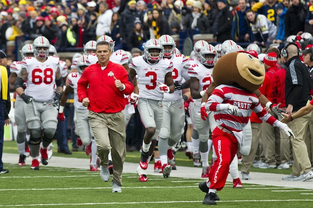 Ohio State head coach Urban Meyer leads his team on to the Michigan Stadium field before an NCAA college football game against Michigan in Ann Arbor, Mich., Saturday, Nov. 28, 2015. (AP Photo/Tony Ding)