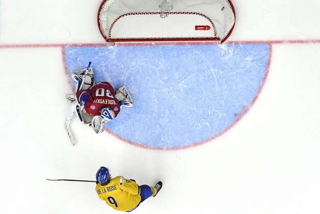 Sweden's Jacob de la Rose, bottom,  scores the winning goal past Russia's goal keeper Andrei Vasilevski in the IIHF World Junior Championship preliminary round group B ice hockey match between Sweden and Russia at Malmo Arena in Malmo, Sweden, on Tuesday  Dec. 31, 2013. (AP Photo/TT/Ludvig Thunman)   SWEDEN OUT