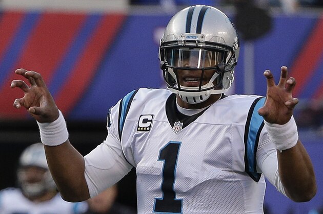 Carolina Panthers quarterback Cam Newton calls an audible at the line of scrimmage during the second half of an NFL football game against the New York Giants, Sunday, Dec. 20, 2015, in East Rutherford, N.J. (AP Photo/Julie Jacobson)