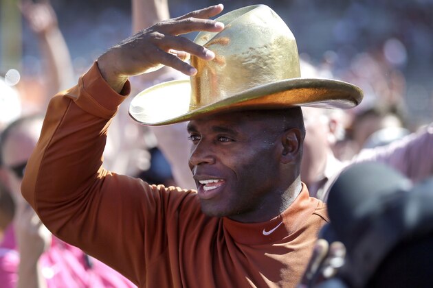 FILE - In this Oct. 10, 2015, file photo, Texas head coach Charlie Strong puts on the Golden Hat as the Longhorns celebrate their win over Oklahoma in an NCAA college football game in Dallas. To turnaround Texas, coach Strong has to be able to recruit in the state at a time when it has never been more competitive. (AP Photo/LM Otero, File)
