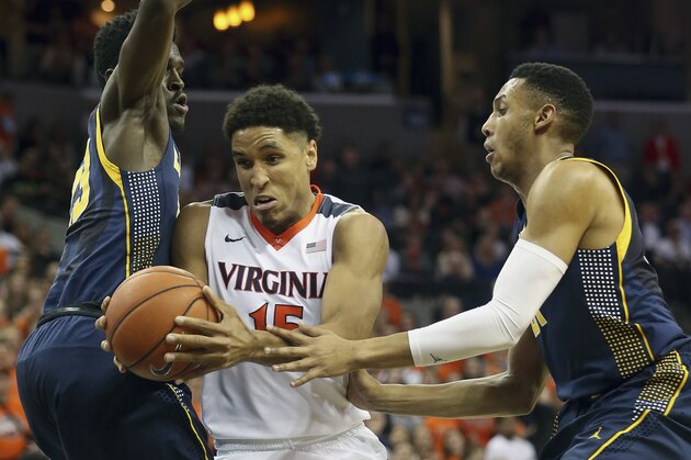 Virginia guard Malcolm Brogdon, center, tries to get past California guard Jabari Bird, left, and Stephen Domingo during an NCAA basketball game Tuesday Dec. 22, 2015, in Charlottesville, Va. (AP Photo/Andrew Shurtleff)
